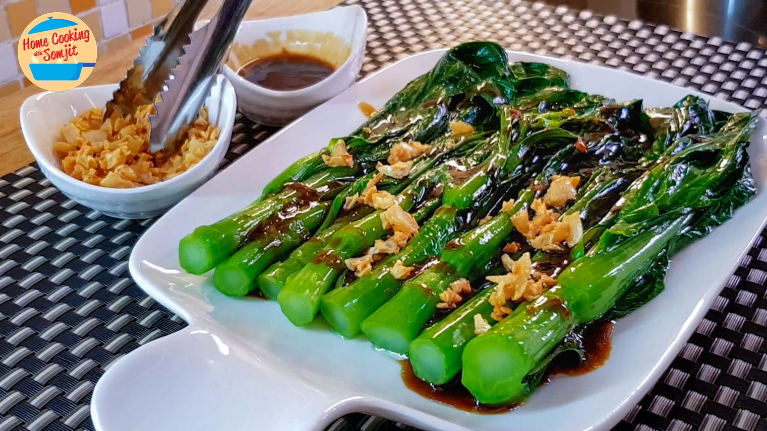 Sprinkling fried garlic over choy sum.